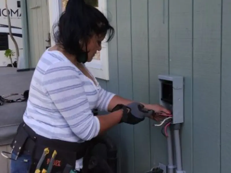 Licensed electrician wiring an exterior subpanel in Socorro